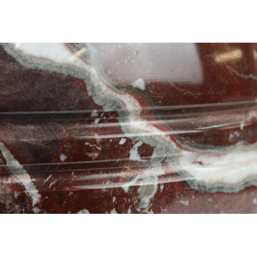 128 - Polished marble vase of spherical footed form, with tones of red and off-white, moulded rim and doub... 