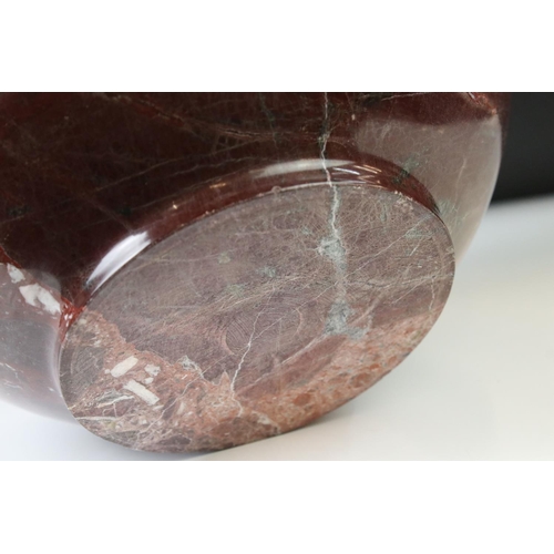 128 - Polished marble vase of spherical footed form, with tones of red and off-white, moulded rim and doub... 