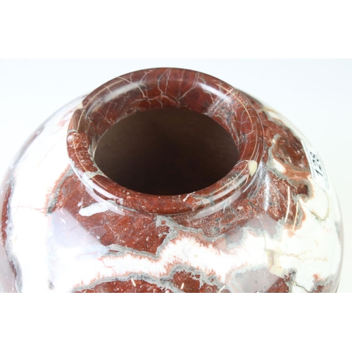 128 - Polished marble vase of spherical footed form, with tones of red and off-white, moulded rim and doub... 