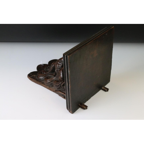 131 - Antique carved oak wall bracket in the form of a lion mask, with square shelf, approx 28cm high