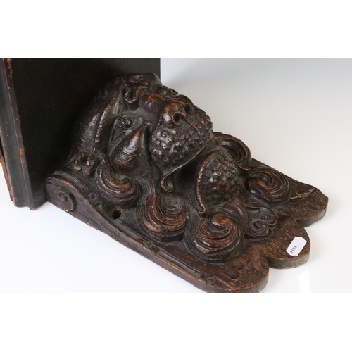 131 - Antique carved oak wall bracket in the form of a lion mask, with square shelf, approx 28cm high