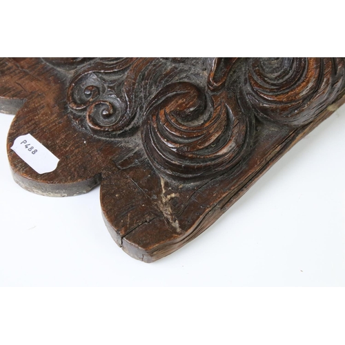 131 - Antique carved oak wall bracket in the form of a lion mask, with square shelf, approx 28cm high