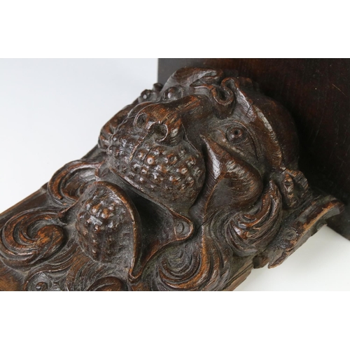 131 - Antique carved oak wall bracket in the form of a lion mask, with square shelf, approx 28cm high