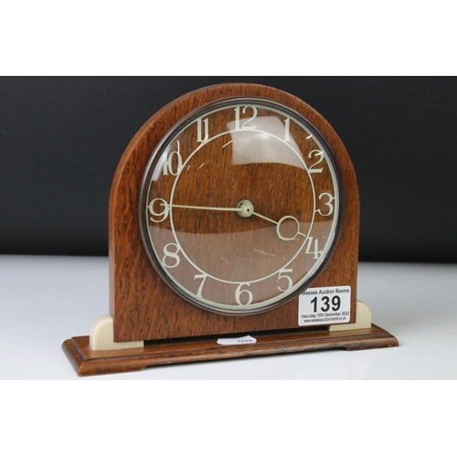 139 - Art Deco style Smiths oak and Bakelite mantle clock of arched form, with cream Arabic numerals, conv... 