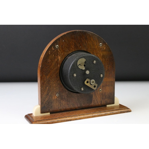 139 - Art Deco style Smiths oak and Bakelite mantle clock of arched form, with cream Arabic numerals, conv... 