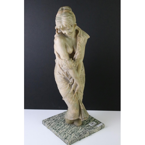 141 - Art Nouveau alabaster figure of a classical maiden, loosely dressed, mounted on a green polished sto... 