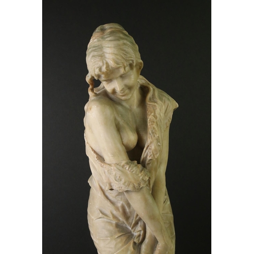 141 - Art Nouveau alabaster figure of a classical maiden, loosely dressed, mounted on a green polished sto... 