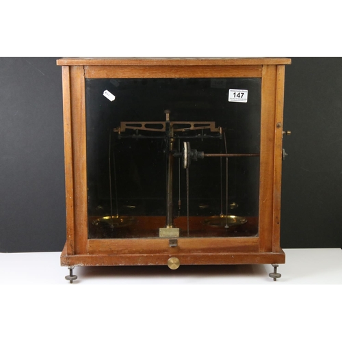 147 - Baird & Tatlock, London set of vintage balance weighing scales housed within a wooden case, with gla... 