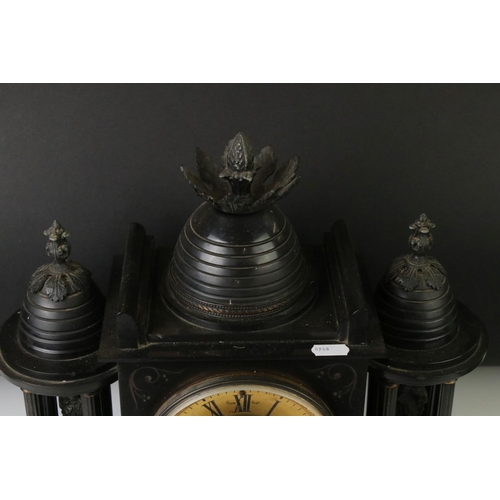 154 - 19th Century slate mantle clock with Roman numerals on a brass dial, flanked by two four-column arch... 