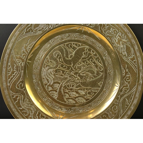 158 - Set of three Chinese brass plates with engraved dragon and Greek key-style decoration, comprising a ... 