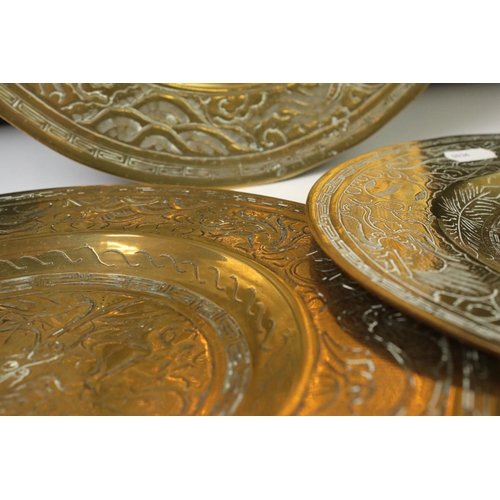 158 - Set of three Chinese brass plates with engraved dragon and Greek key-style decoration, comprising a ... 