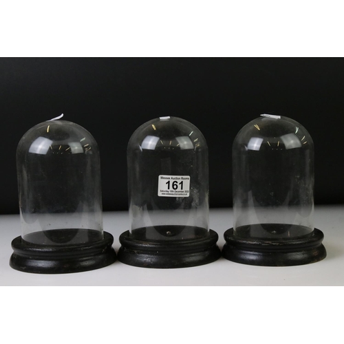 161 - Set of three vintage glass display domes, each approx 18cm in height, on ebonised wooden bases