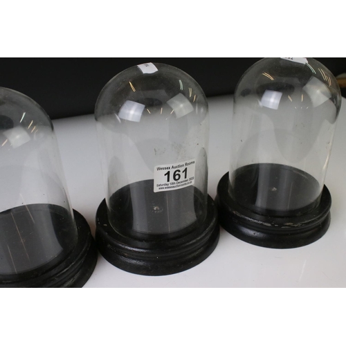 161 - Set of three vintage glass display domes, each approx 18cm in height, on ebonised wooden bases