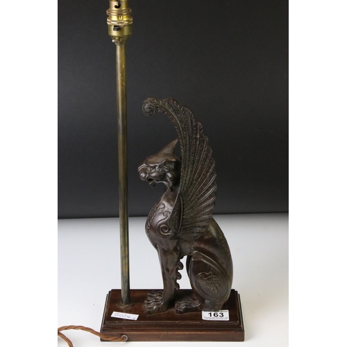 163 - 19th century cast iron model of a winged lion, left ear missing, height approx. 32cm, mounted as a t... 