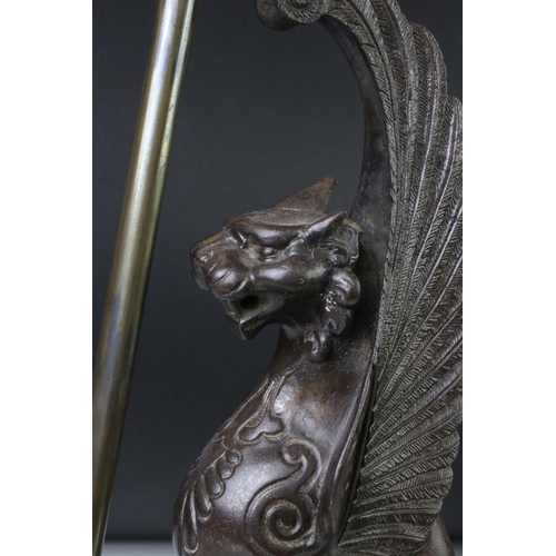 163 - 19th century cast iron model of a winged lion, left ear missing, height approx. 32cm, mounted as a t... 