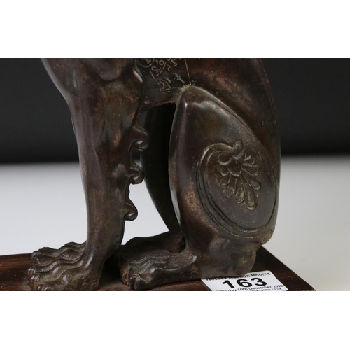 163 - 19th century cast iron model of a winged lion, left ear missing, height approx. 32cm, mounted as a t... 