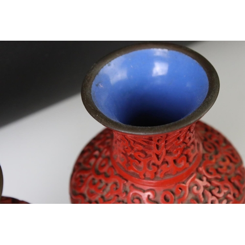 168 - Five pieces of 20th century Chinese cinnabar lacquer ware comprising a pair of baluster vases depict... 