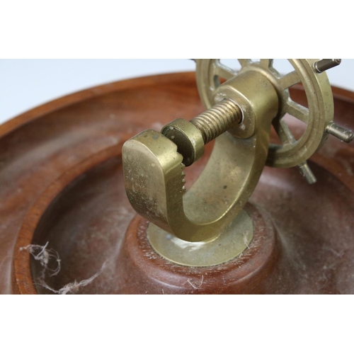 175 - Novelty turned wooden nut dish mounted with a brass ship's wheel nutcracker, approx 29cm diameter