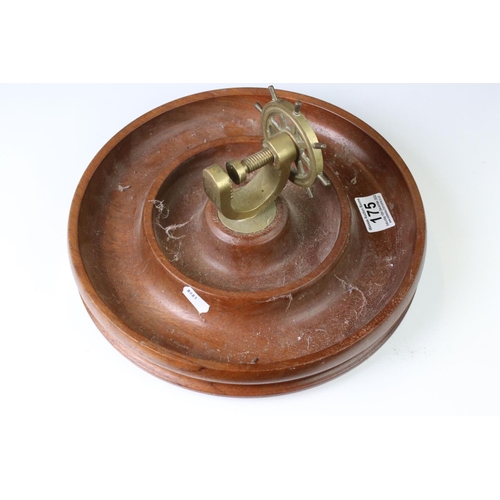 175 - Novelty turned wooden nut dish mounted with a brass ship's wheel nutcracker, approx 29cm diameter