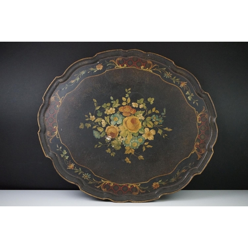 86 - Black Lacquered Papier Mache Oval Tray with shaped edge decorated with flowers, 52cm long