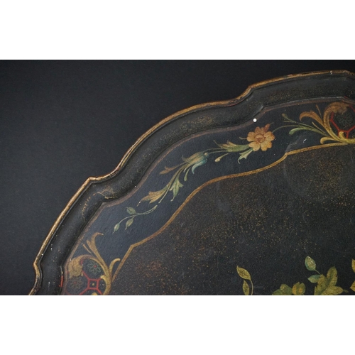 86 - Black Lacquered Papier Mache Oval Tray with shaped edge decorated with flowers, 52cm long
