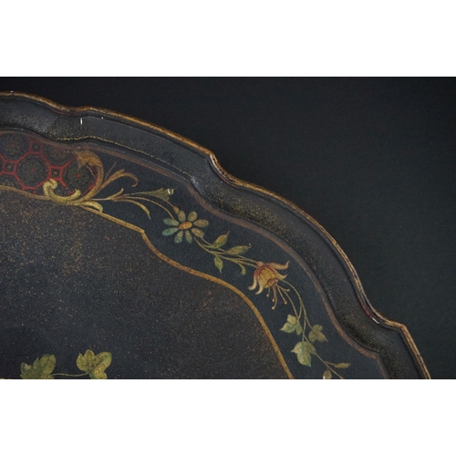 86 - Black Lacquered Papier Mache Oval Tray with shaped edge decorated with flowers, 52cm long