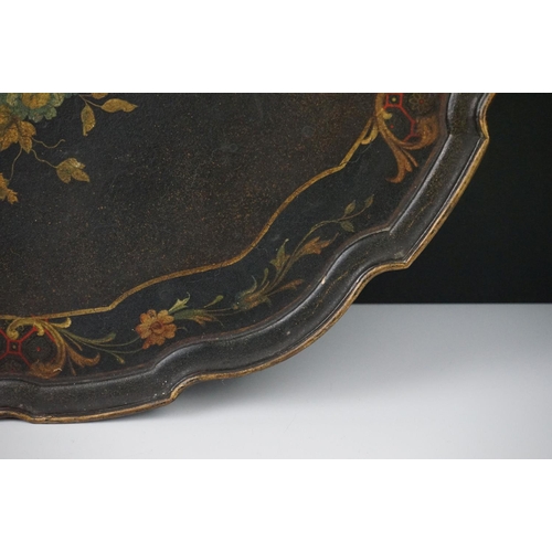 86 - Black Lacquered Papier Mache Oval Tray with shaped edge decorated with flowers, 52cm long
