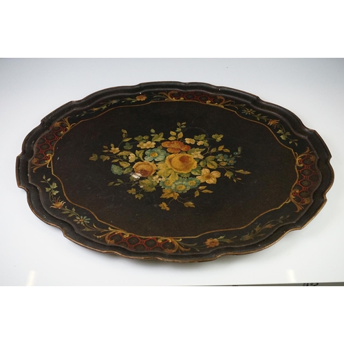 86 - Black Lacquered Papier Mache Oval Tray with shaped edge decorated with flowers, 52cm long