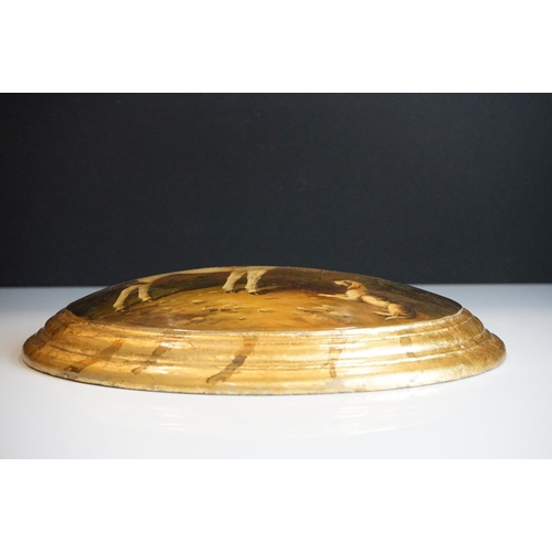 88 - Lacquered Domed Oval Plaque decorated with a Horse and a Dog outside of gates, signed, 32cm long