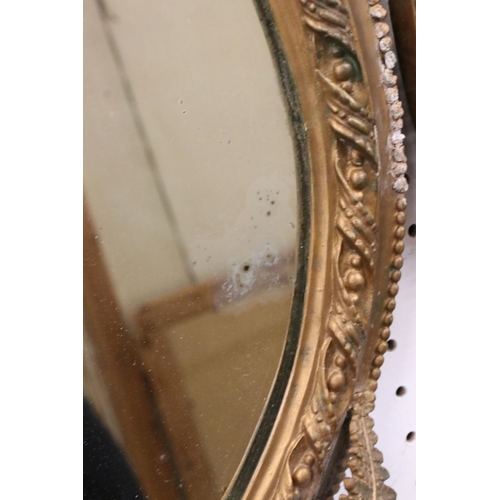 545 - Pair of 19th century Plaster Gilt Wall Mirrors, the oval plates within bead frames surmounted by fer... 