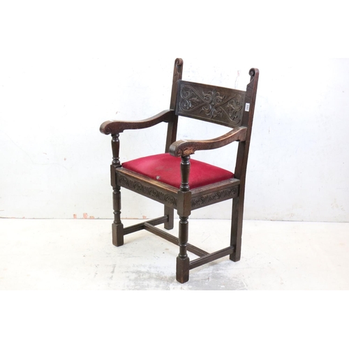 550 - In the manner of Liberty of London, Gothic Revival Oak Elbow Chair with carved back rail and upholst... 