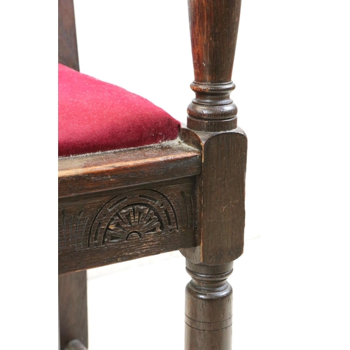 550 - In the manner of Liberty of London, Gothic Revival Oak Elbow Chair with carved back rail and upholst... 