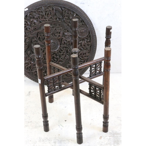 553 - Moorish Circular Hardwood Folding Table, the circular scrolling foliate top raised on a folding base... 