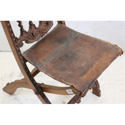 574 - Moorish Hardwood Carved Folding Chair with embossed leather seat, 84cm high x 37xm wide