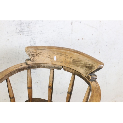 593 - Late 19th / Early 20th century Elm Seated Captain's style Tub Chair raised on later castors, 63cm wi... 