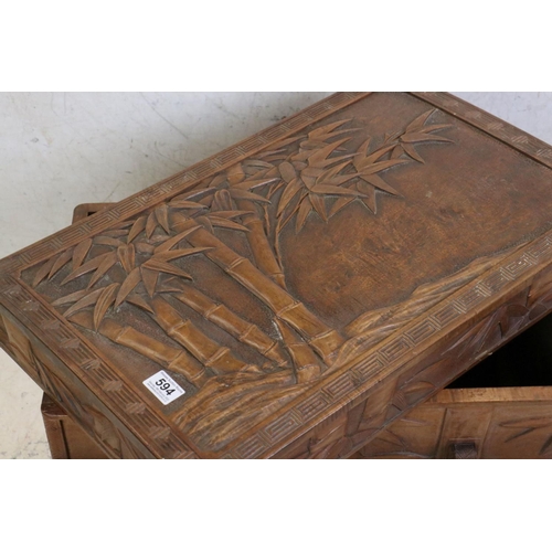 594 - South East Asian Hardwood Box with lift off lid, carved to all sides with bamboo trees, raised on si... 