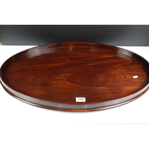 112 - Early 20th century mahogany oval serving tray of plain form (70cm long), together with a set of five... 