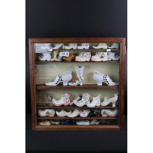 128 - Collection of 36 ceramic & glass shoes to include Palissy, Kildsware and Old Foley examples, housed ... 