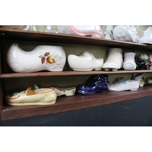 128 - Collection of 36 ceramic & glass shoes to include Palissy, Kildsware and Old Foley examples, housed ... 