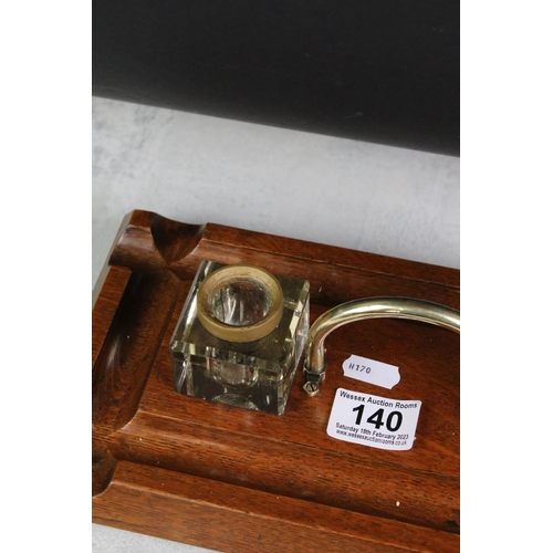 140 - Early 20th Century oak double inkwell desk stand with brass loop handle and square-shaped inkwells w... 