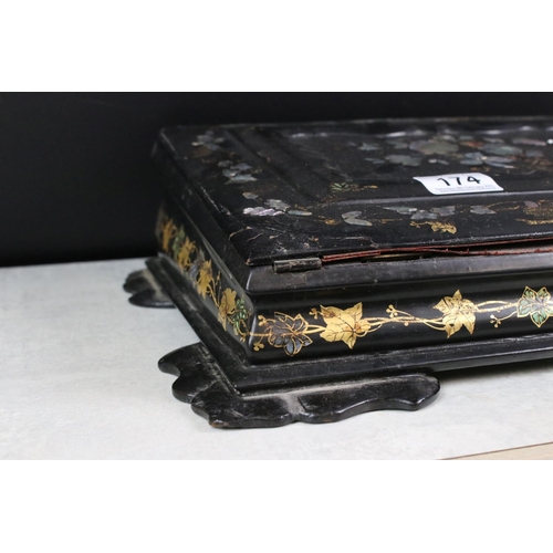 174 - Victorian black lacquered writing slope with abalone shell floral inlay to the hinged lid, gilt pain... 