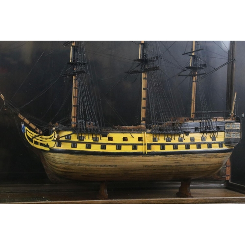 176 - Scratch-built painted wooden model of a 64 Gun Ship (1750), with detailed rigging, cased, measures a... 