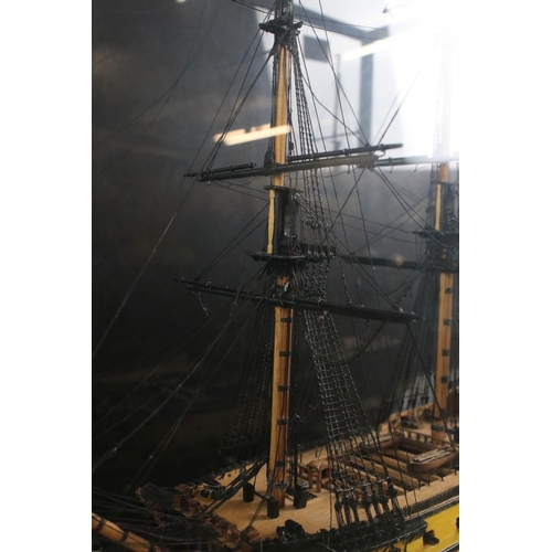 176 - Scratch-built painted wooden model of a 64 Gun Ship (1750), with detailed rigging, cased, measures a... 