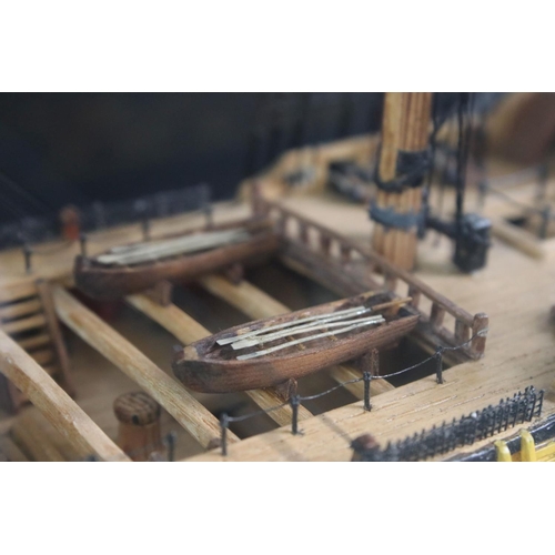 176 - Scratch-built painted wooden model of a 64 Gun Ship (1750), with detailed rigging, cased, measures a... 