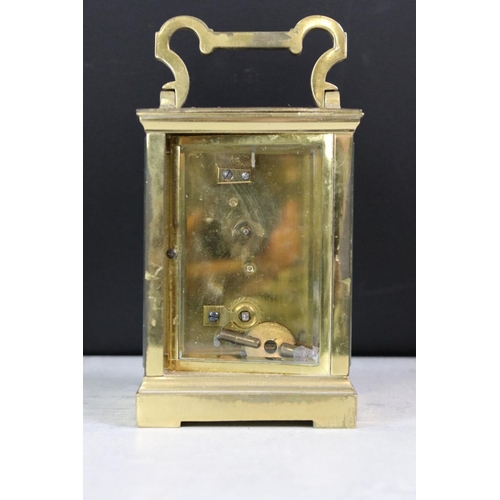 195 - A small group of collectables to include a brass cased carriage clock, money box / cash tin, tape me... 