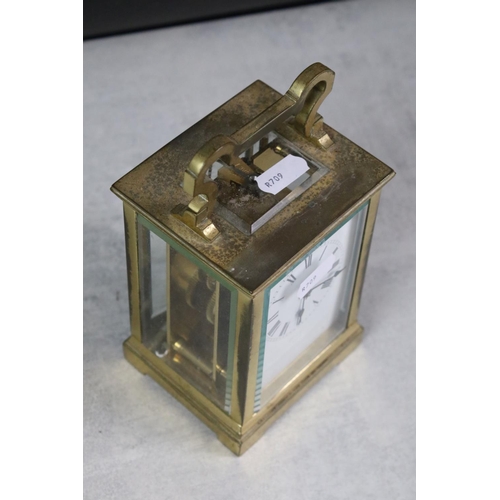 195 - A small group of collectables to include a brass cased carriage clock, money box / cash tin, tape me... 