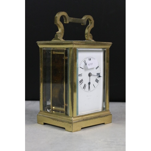 195 - A small group of collectables to include a brass cased carriage clock, money box / cash tin, tape me... 