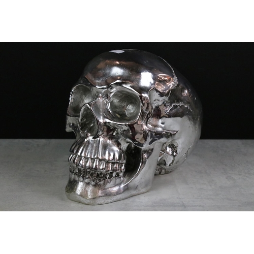 372 - Model of a Silvered Skull together with Two Brass Hot Water Bottles