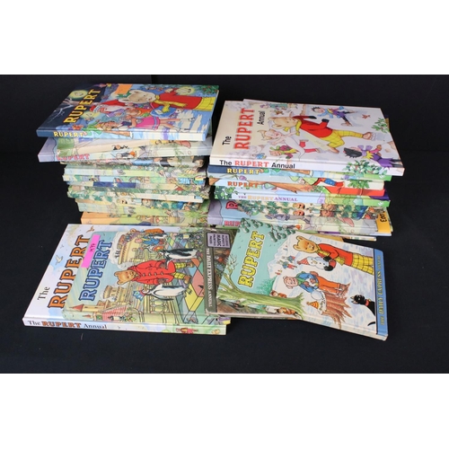 415 - A large collection of approx eighty Rupert the Bear annual and books dating from the 1960's onwards.