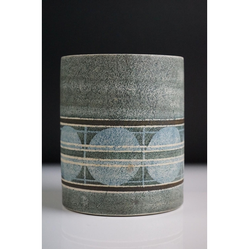 14 - Troika pottery cylindrical lamp base decorated with a striped band of circles on a textured grey gro... 